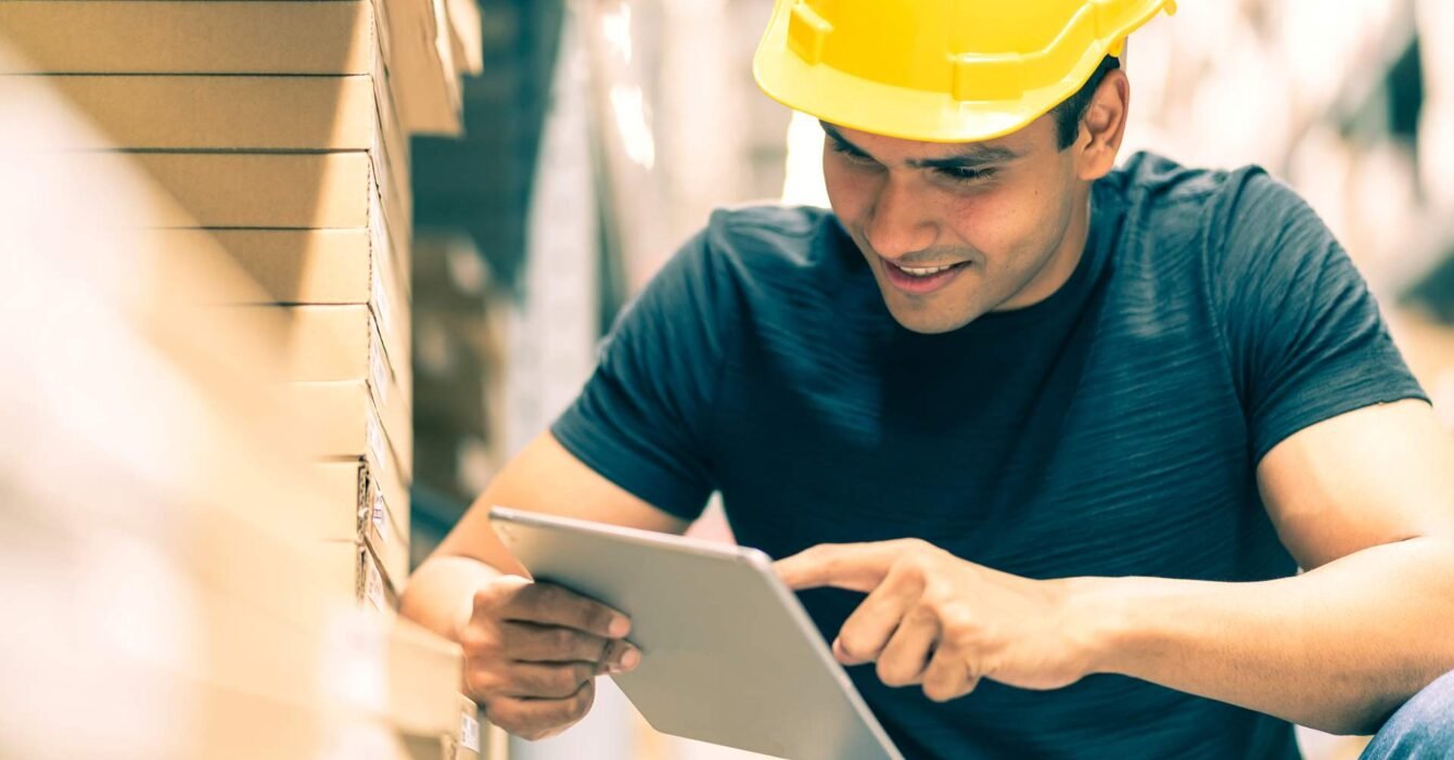 smart-indian-engineer-man-wearing-safety-helmet-doing-stock-tick-check-cardboard-stock-product-management-factory-warehouse-background (1)